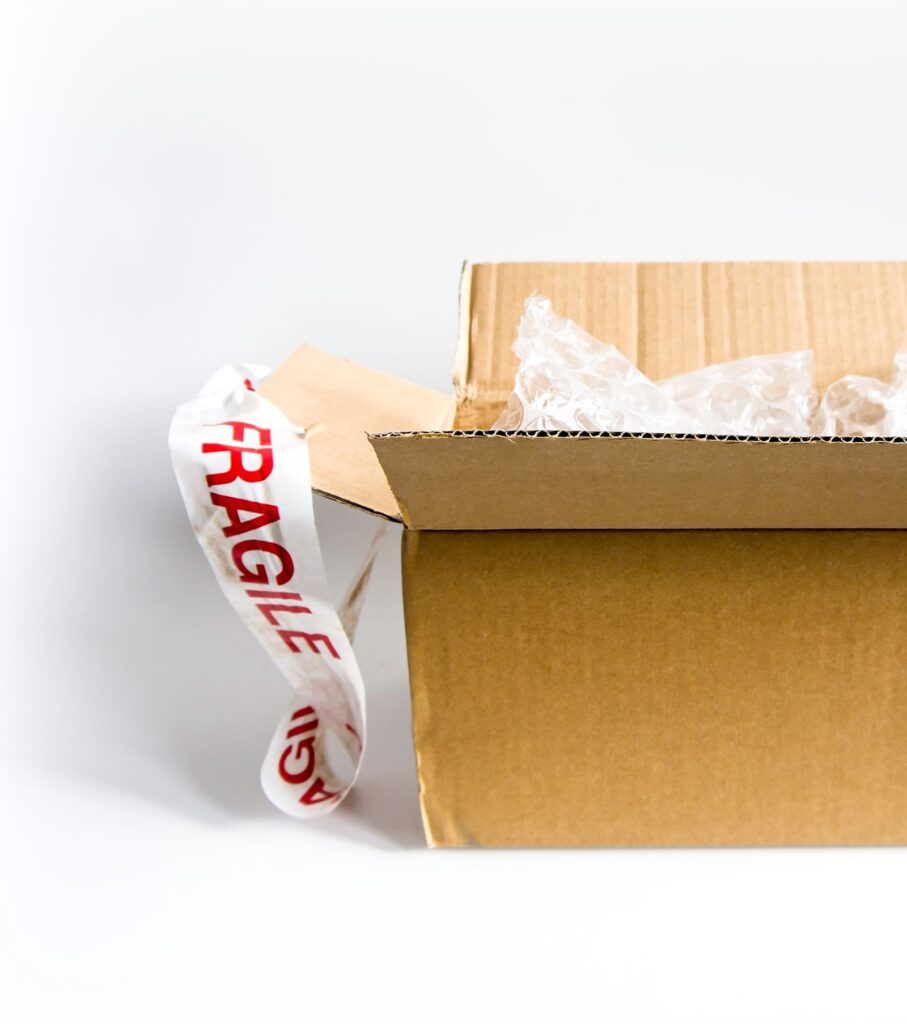Caja de envío con cinta de frágil y plástico de burbujas
